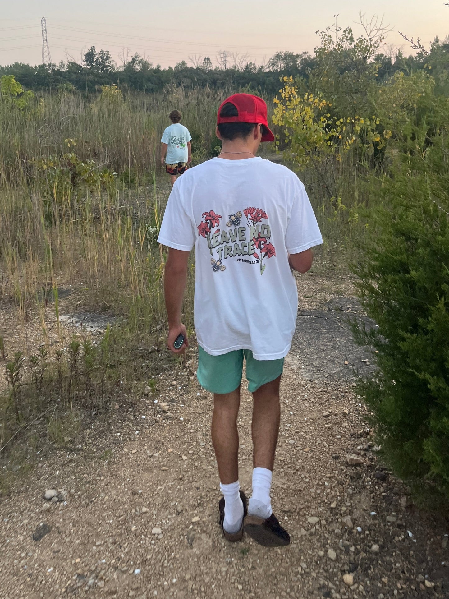 Boy modeling Vistathread Leave No Trace Wildflower t-shirt while walking